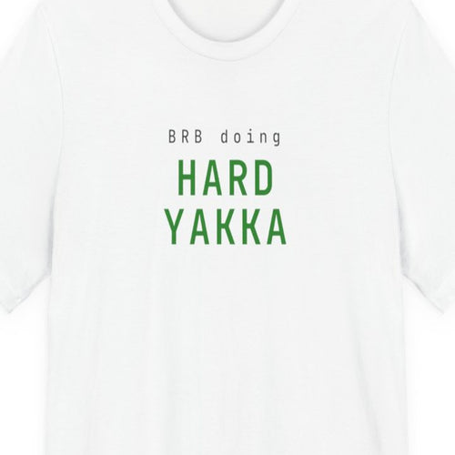 Black t-shirt with "BRB Doing Hard Yakka" text in amber terminal-style font on dark background