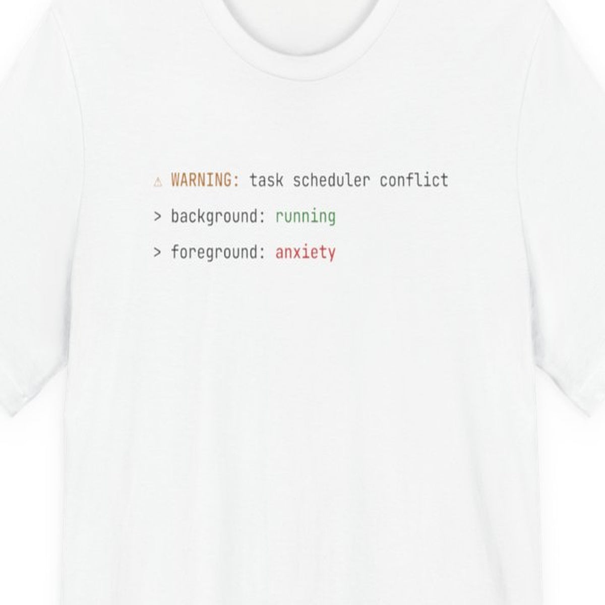 Black t-shirt with "Background Task, Foreground Anxiety" text in monospace amber font on dark background