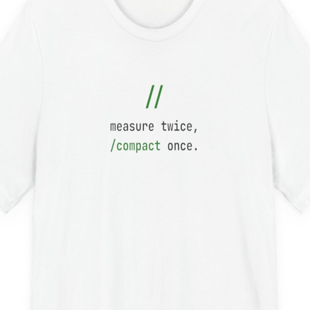 Black t-shirt with white monospace text reading "Measure Twice, /compact Once" in terminal-style font