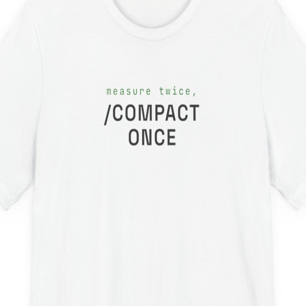 Black t-shirt with white text reading "Measure Twice, /compact Once" in monospace font on dark background