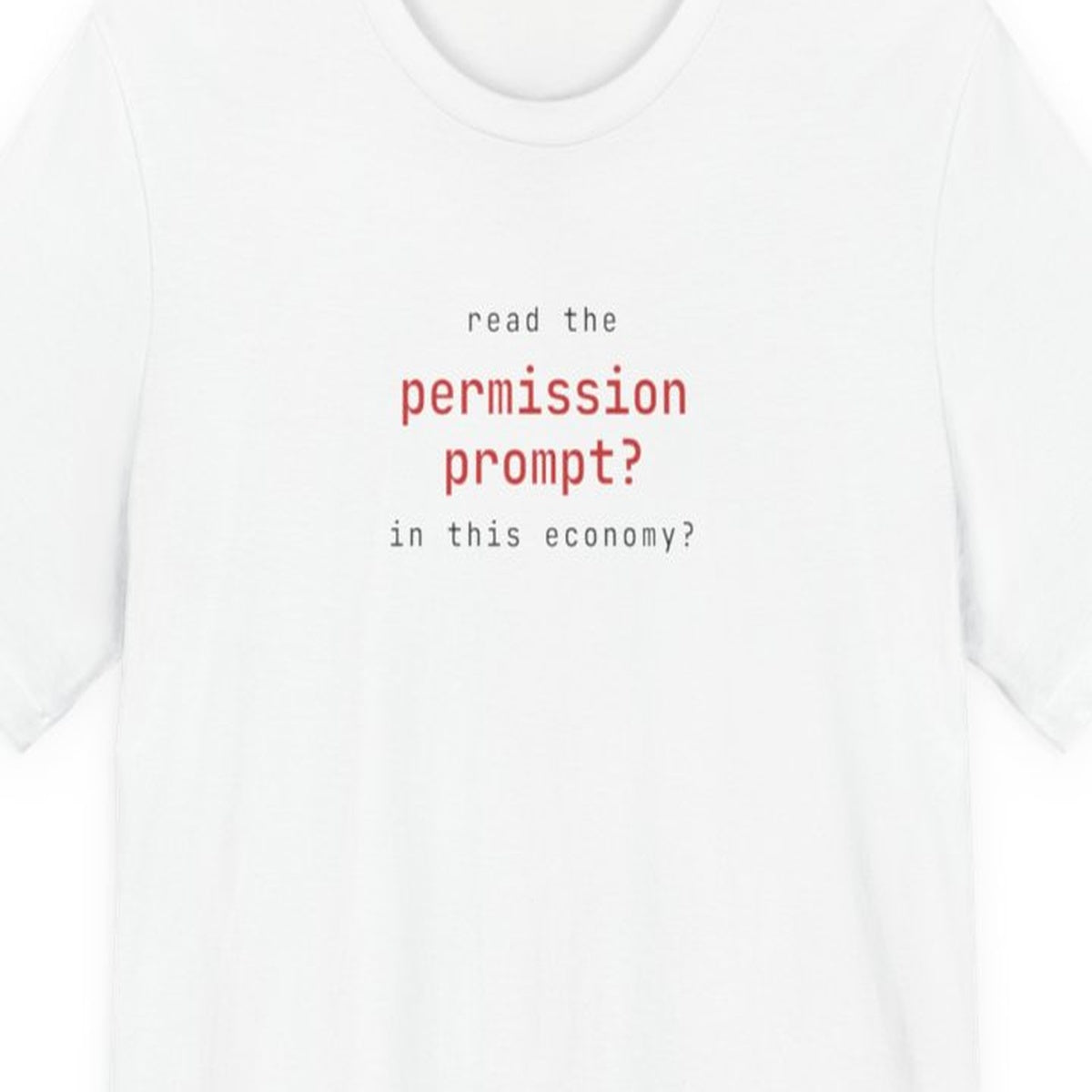 Black t-shirt with white text reading "Read the Permission Prompt? In This Economy?" in monospace developer font